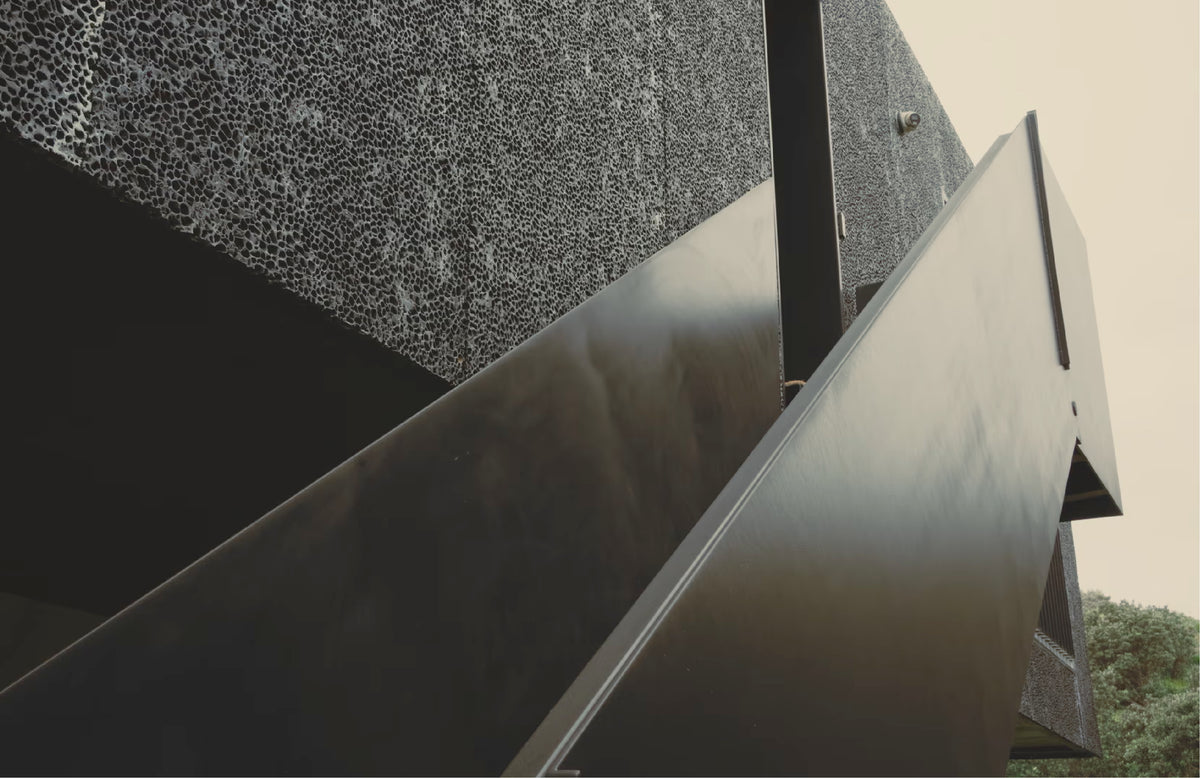 Close-up of modern architecture with sharp lines and textured surfaces.